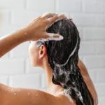 woman cleaning hair shower